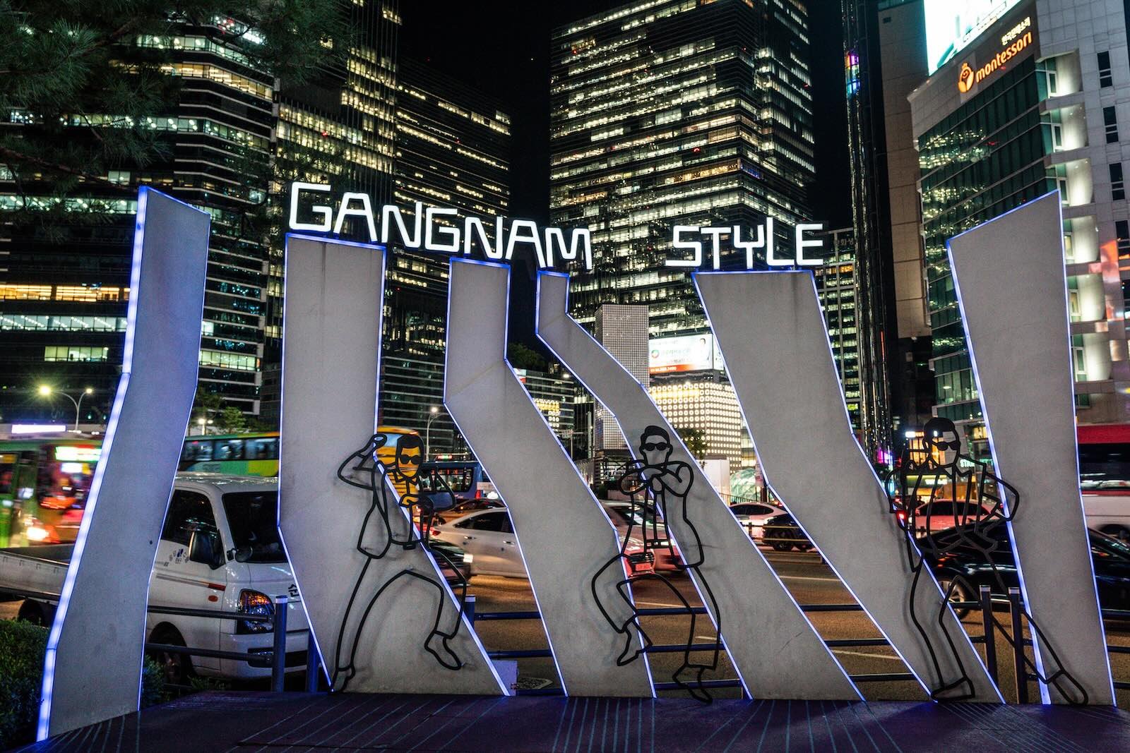 Gangnam Station with Gangnam Style neon signs and buildings in the background